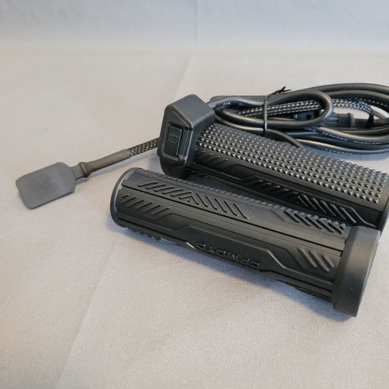 a black device with a cable CF MOTO Handtagsvärmare C-FORCE 2023-